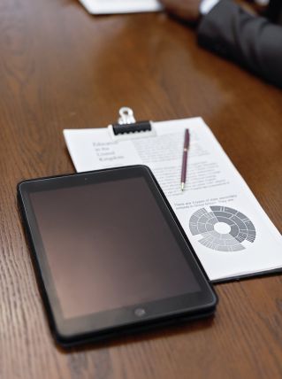 Black Tablet Computer on White Paper